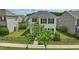 Charming two-story home with black shutters and a well-manicured lawn surrounded by a black fence at 704 Moonbeam Dr, Raleigh, NC 27603