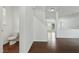 Foyer with hardwood floors, stairs, and a half bath at 704 Moonbeam Dr, Raleigh, NC 27603