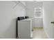 Laundry room featuring two white washing machines and a window at 704 Moonbeam Dr, Raleigh, NC 27603