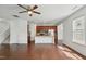 An open floor plan features a kitchen with an island, hardwood floors, and modern appliances at 704 Moonbeam Dr, Raleigh, NC 27603