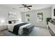 Serene main bedroom featuring a ceiling fan, two windows, and stylish décor at 704 Moonbeam Dr, Raleigh, NC 27603