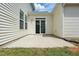 A concrete patio with sliding glass doors provides access to the backyard at 704 Moonbeam Dr, Raleigh, NC 27603