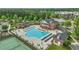 Stunning aerial view of a community pool and tennis courts with sun loungers and tables for residents' enjoyment at 704 Moonbeam Dr, Raleigh, NC 27603