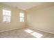 Bedroom with neutral carpet, two windows providing ample light, and painted walls, ready for personalization at 7229 Terregles Dr, Raleigh, NC 27617