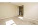 Bedroom with neutral carpet and painted walls, featuring access to a staircase at 7229 Terregles Dr, Raleigh, NC 27617