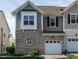 Two-story townhome with brick facade, attached one-car garage, and well-maintained front lawn at 7229 Terregles Dr, Raleigh, NC 27617