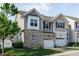 Charming townhome featuring a front yard, garage, and beautiful architectural details at 7229 Terregles Dr, Raleigh, NC 27617