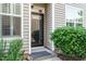 Inviting front entrance features decorative shrubbery and sidelight window at 7229 Terregles Dr, Raleigh, NC 27617
