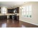 Well-equipped kitchen with stainless steel appliances, dark cabinets, and hardwood floors at 7229 Terregles Dr, Raleigh, NC 27617
