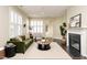 Inviting living room features large shuttered windows and a cozy fireplace at 7229 Terregles Dr, Raleigh, NC 27617