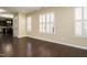 Bright living room showcasing hardwood floors, shutters, and an open layout to the kitchen at 7229 Terregles Dr, Raleigh, NC 27617
