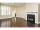Bright living room showcases hardwood floors, shuttered windows, and a charming fireplace at 7229 Terregles Dr, Raleigh, NC 27617
