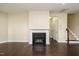 Cozy living room featuring a fireplace, hardwood floors, and staircase at 7229 Terregles Dr, Raleigh, NC 27617