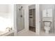 Well-lit bathroom featuring a glass shower, soaking tub, and closet at 7940 Milltrace Run, Raleigh, NC 27615