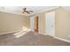 Standard bedroom with carpet, ceiling fan, and closet space at 7940 Milltrace Run, Raleigh, NC 27615
