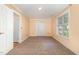 A bright bedroom offers neutral carpet, painted walls, and a window with exterior views at 7940 Milltrace Run, Raleigh, NC 27615