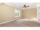 This bedroom has neutral walls, neutral carpet, and a window that lets in natural light at 7940 Milltrace Run, Raleigh, NC 27615