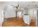 Bright, open-concept living room with hardwood floors, a fireplace, and access to the kitchen at 7940 Milltrace Run, Raleigh, NC 27615