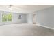 Spacious bedroom features a ceiling fan, neutral paint, gray carpet, and a bright window at 84 N Hadrian Ct, Clayton, NC 27520