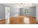Large primary bedroom boasts natural lighting, ceiling fan, and hardwood floors at 84 N Hadrian Ct, Clayton, NC 27520