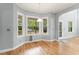 Bright dining area with hardwood floors and pool view from the many large windows at 84 N Hadrian Ct, Clayton, NC 27520
