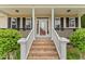 Charming front entrance with brick steps, white pillars, and a decorative front door at 84 N Hadrian Ct, Clayton, NC 27520