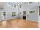 Bright living room featuring tall windows, a fireplace, and hardwood floors at 84 N Hadrian Ct, Clayton, NC 27520