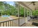 A screened-in porch with a view of a luxurious pool and a wooded backyard at 84 N Hadrian Ct, Clayton, NC 27520