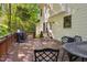 Spacious back deck with a grill and outdoor seating area, overlooking a wooded backyard at 8401 Hobhouse Cir, Raleigh, NC 27615