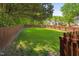 Wide backyard featuring a wooden fence and mature trees at 8401 Hobhouse Cir, Raleigh, NC 27615