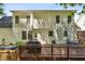 Backyard with a wooden deck, dark metal outdoor dining set, grill and light siding at 8401 Hobhouse Cir, Raleigh, NC 27615