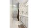 Well-maintained bathroom with white tile flooring, shower and modern vanity at 8401 Hobhouse Cir, Raleigh, NC 27615