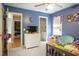 bedroom with blue accent wall, dresser and shared access to Jack and Jill bath at 8401 Hobhouse Cir, Raleigh, NC 27615