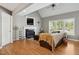 Cozy living room featuring a fireplace, vaulted ceilings, hardwood floors, and natural light at 8401 Hobhouse Cir, Raleigh, NC 27615