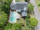 Aerial view of a meticulously landscaped property, highlighting the in-ground pool, outdoor seating, and manicured lawn at 101 Conway Ct, Cary, NC 27513