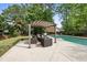 Relaxing backyard space featuring a cozy pergola-covered seating area and an inviting in-ground pool at 101 Conway Ct, Cary, NC 27513