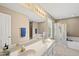 Bright bathroom featuring double sinks, large soaking tub and glass-enclosed shower at 101 Conway Ct, Cary, NC 27513