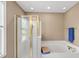 Bright bathroom showcasing glass-enclosed shower and a luxurious soaking tub at 101 Conway Ct, Cary, NC 27513