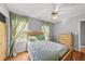 Bright bedroom featuring hardwood floors, a ceiling fan, and two bright windows at 101 Conway Ct, Cary, NC 27513