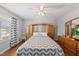 Comfortable bedroom featuring hardwood floors, a ceiling fan, and a large window at 101 Conway Ct, Cary, NC 27513