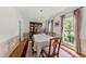 Elegant dining room with hardwood floors, a china cabinet, and natural light from the window at 101 Conway Ct, Cary, NC 27513