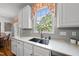 The kitchen offers a double basin sink beneath a window, gray subway tile, and modern white cabinetry at 101 Conway Ct, Cary, NC 27513