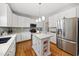 Modern kitchen with white cabinetry, stainless steel appliances, and a center island, perfect for cooking and entertaining at 101 Conway Ct, Cary, NC 27513