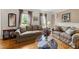 Cozy living room with classic furnishings, hardwood floors, and large windows at 101 Conway Ct, Cary, NC 27513