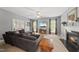 Cozy living room with a fireplace, large sofa, and a ceiling fan, perfect for relaxing and entertaining guests at 101 Conway Ct, Cary, NC 27513