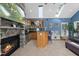 A sunroom features a stone fireplace, wet bar, and abundant natural light through skylights at 101 Conway Ct, Cary, NC 27513