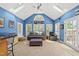 Bright living room featuring skylights, blue walls, tile flooring, and a vaulted ceiling at 101 Conway Ct, Cary, NC 27513