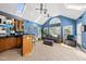 The sunroom features a vaulted ceiling with skylights, a bar, tile flooring, and stylish blue walls at 101 Conway Ct, Cary, NC 27513