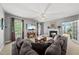 Spacious living room with a fireplace, a large sectional sofa, and a ceiling fan, perfect for entertaining and relaxation at 101 Conway Ct, Cary, NC 27513