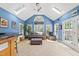 Bright sunroom with blue walls, skylights, tile flooring, and ample natural light at 101 Conway Ct, Cary, NC 27513
